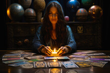 A Female Fortune Teller, With An Array Of Mystical Tarot Cards Displayed On A Table