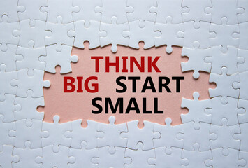 think big start small symbol. concept words think big start small on white puzzle. beautiful pink ba