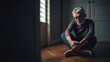 © Yeti Studio - Depressed senior man sitting on floor at home. Copy space