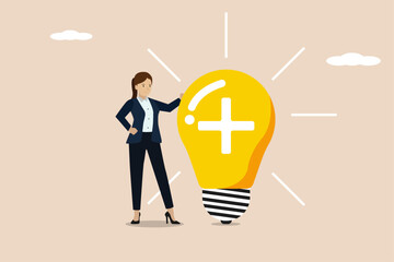 Wall Mural - Positive thinking, inspiration and happiness at work concept, businesswoman standing with bright light bulb idea with positive sign.