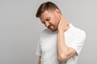 © DimaBerlin - Unhealthy man suffering painful neck ache after sports exercise. Guy rubbing muscles to relieve pain or nerve spasm. Back pain and hernia, sedentary lifestyle concept. Health problems after 40.