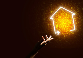 Conceptual image with hand pointing at house or main page icon on dark background