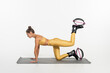 © LIGHTFIELD STUDIOS - kangoo jumping shoes, young woman in active wear exercising on fitness mat, athlete with toned body