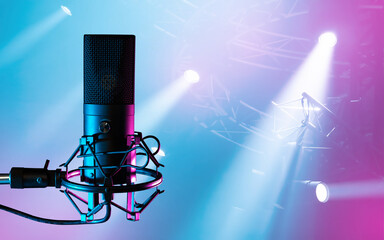 Wall Mural - Condenser microphone. Mic on tripod. Concert spotlights near microphone. Sound recording equipment. Audio technologies. Microphone for concert venue. Professional mic for concerts.