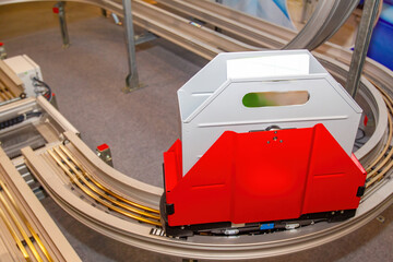 Poster - Narrow conveyor. Automated line for supply of goods. Conveyor inside book depository. Production line. Container on automatic conveyor. Warehouse robot for automated product selection