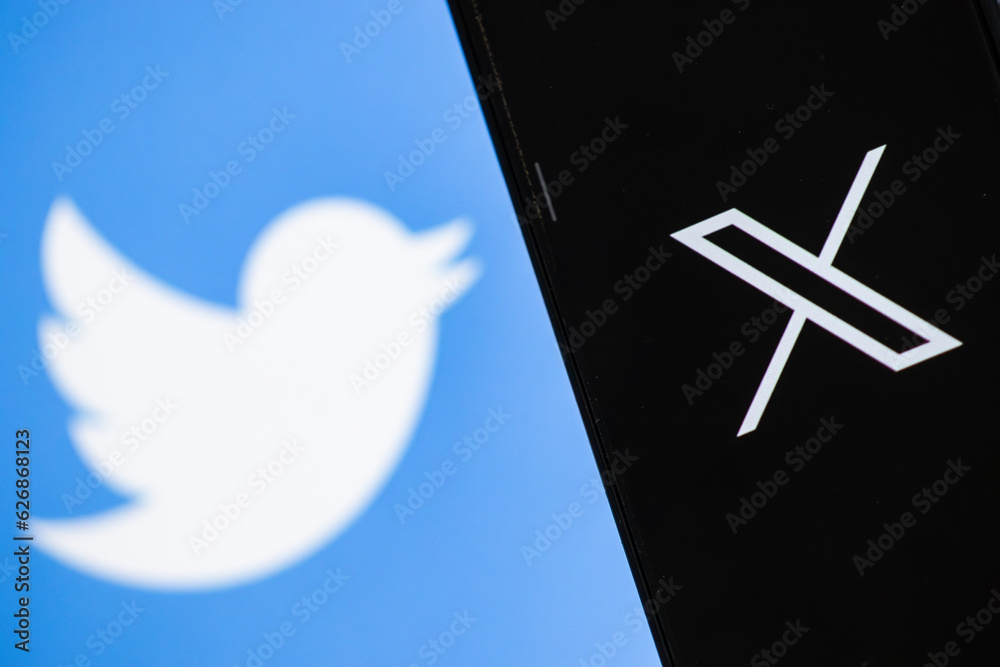 New Twitter logo X. Elon Musk change Twitter logo. Smartphone with Twitter logo on the screen.