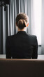 Back view of a woman in a suit waiting for a job interview, generated AI