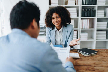 Real estate african american are delivering keys and houses to customers after agreeing to make a home purchase agreement and make a loan agreement or insurance