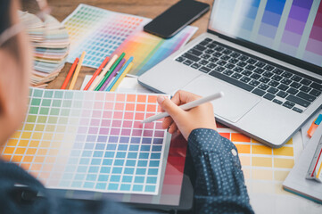 Fototapete - Graphic designer architects who work with laptops and color comparison tables for design work..