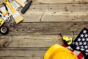 Wall Mural - Happy Labor Day concept. Greeting card design with toolbox, safety helmet, worker tools on wooden table. Flat lay, top view.