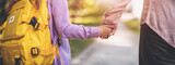 Fototapeta Natura - Mother holding the hand of a daughter and escorting her to school.