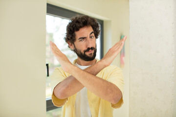 Sticker - young crazy bearded man looking annoyed and sick of your attitude, saying enough! hands crossed up front, telling you to stop