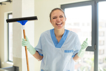 Wall Mural - pretty woman feeling shocked,laughing and celebrating success. housekeeper concept