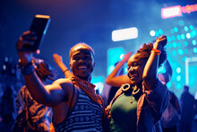 Happy Black Couple Taking Selfie While Dancing At Open Air Music Concert At Night.