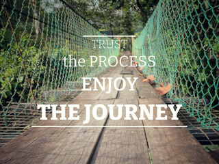 Inspirational and Motivational Quote - trust the process enjoy the journey. Blurry background.