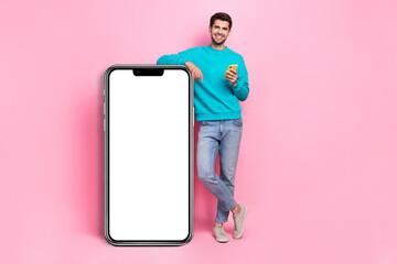 Sticker - Full body photo of attractive young man hold device lean on blank banner dressed stylish blue clothes isolated on pink color background