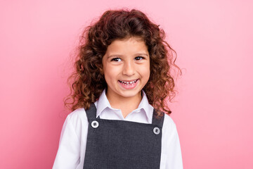 Wall Mural - Portrait of positive cheerful schoolkid beaming smile look empty space ad isolated on pink color background