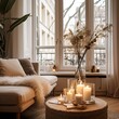 Warm cozy home interior with burning candles, afternoon room decoration, creative decor arrangement