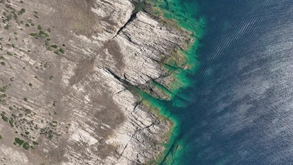 Wall Mural - view from the air on the waves and rocks. sea relaxation and travel. azure water on the sea. a brigh