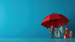 © MP Studio - Plastic figures in the form of a family protected by a red umbrella. Insurance concept. Created with Generative AI technology.