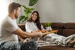 © ivanko80 - Young couple having breakfast in living room
