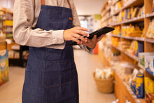 Anonymous Man With Tablet Checking Goods In Grocery Store