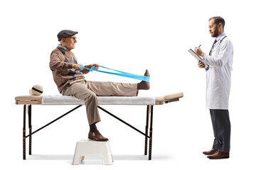 Wall Mural - Elderly man exercising with a stretch band and sitting on a therapy bed and a doctor writing a document