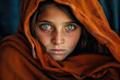 A beautiful woman wearing an orange shawl over their head with beautiful eyes