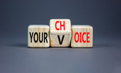 Your voice choice symbol. Businessman turns wooden cubes and changes the concept word Your choice to voice. Beautiful grey table grey background, copy space. Business and your voice choice concept
