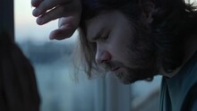 Depressed Man Close Eyes, Thinking About Problems Near Window. Close Up Of Pensive, Sad Depressed Unhappy Beard Man With Long Hair. Mental Health, Man In Tears, Man Cry Depression Concept. Authentic