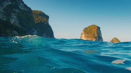 Wall Mural - Splitted underwater view of the mountains and blue sea