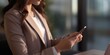 © OP38Studio - Close up businesswoman using mobile smartphone in office. Small business entrepreneur looking at her mobile phone, generative ai