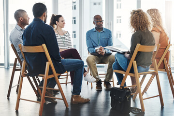 Poster - Gathered round for a meeting. Shot of a group of diverse creative employees having a meeting inside.