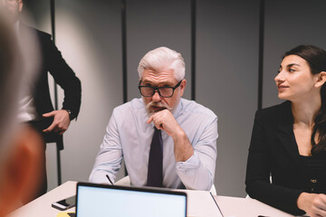 Sticker - Serious senior man in glasses speaking during meeting