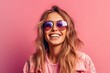 © stasknop - smiling pretty girl in sunglasses on a pink background