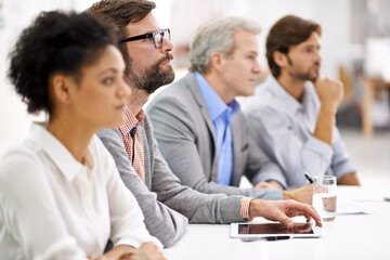 Aufkleber - project debriefing. shot of a group of dedicated business professionals sitting in a row.