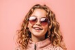 © stasknop - pretty girl in sunglasses on a pink background smiling widely