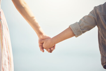 Love, support and holding hands with mother and child for trust, happy and safety on blue sky. Happiness, security and faith with closeup of woman and kid for family, care and kindness together