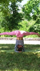 Sticker - Young girl training outdoors in early summer morning, in park, doing yoga and stretching exercises. Concept of healthy and sportive lifestyle, body care, meditation, active life