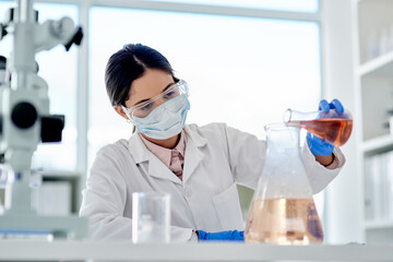 Aufkleber - I hope this reacts as I expect it to. Shot of a young scientist doing an experiment in a lab.