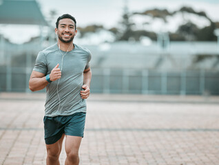sports, portrait and male athlete running with earphones for music, radio or podcast for motivation.