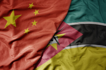 Wall Mural - big waving national colorful flag of china and national flag of mozambique .