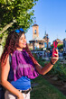 © Sangiao_Photography - Alcala de Henares. Latin mid-woman travel holiday lifestyle portrait happy with smartphone in Spain