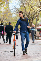 Poster - Getting around the green way. Full length shot of a handsome man in the city with his bicycle.