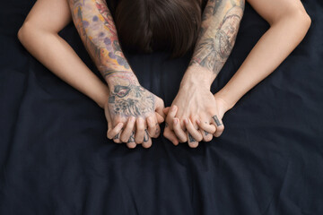 Wall Mural - passionate couple having sex on bed, closeup of hands