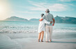 © Daniels C/peopleimages.com - Back, hug or old couple on beach to relax with love, care or support on summer vacation in nature. Retirement, mature man or senior woman at sea or ocean to travel on holiday together looking at view