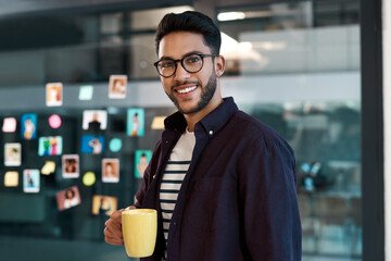 Aufkleber - Caffeine helps me get through the day. Cropped portrait of a handsome young businessman wearing spectacles and standing in his office while drinking a cup of coffee.