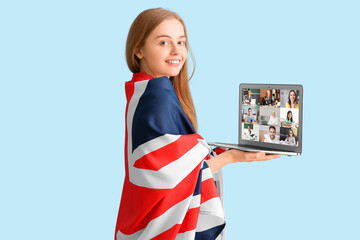 Wall Mural - Young woman with flag of United Kingdom and laptop on light blue background. Concept of online education