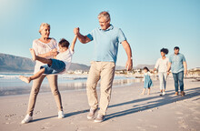 Swinging, Grandparents And A Child Walking On The Beach On A Family Vacation, Holiday Or Adventure In Summer. Young Boy Kid Holding Hands With A Senior Man And Woman Outdoor With Fun Energy Or Game