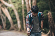 © Charnchai saeheng - Hikers use trekking pole with backpacks and hold tent bag walking through the forest. hiking and adventure concept.